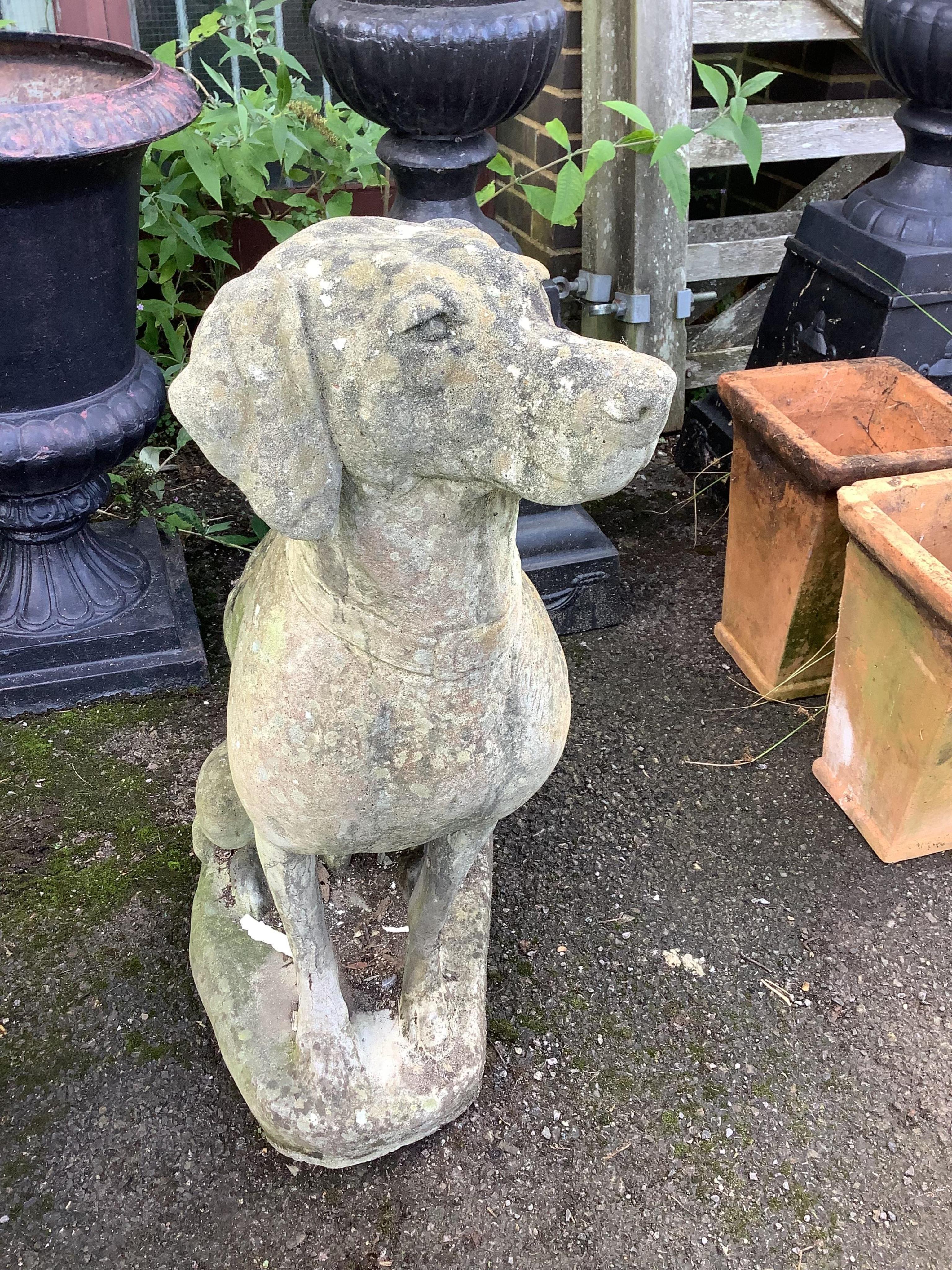 A reconstituted stone model of a seated hound, height 88cm. Condition - weathered, otherwise good